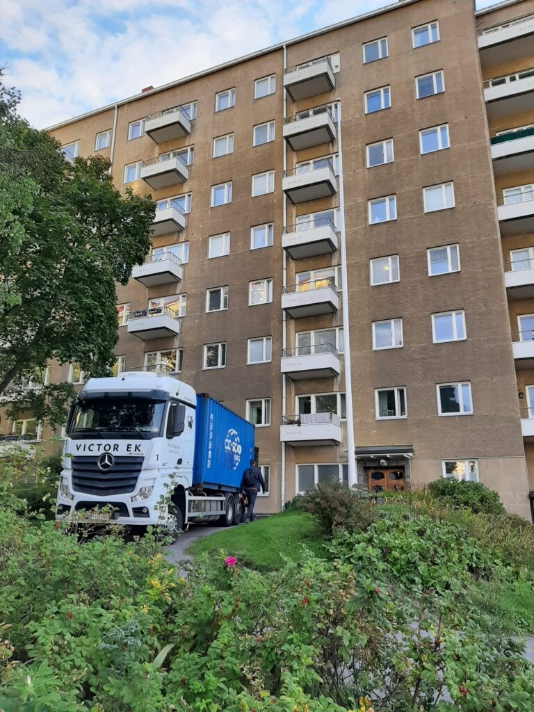 Delivery truck outside apartment building