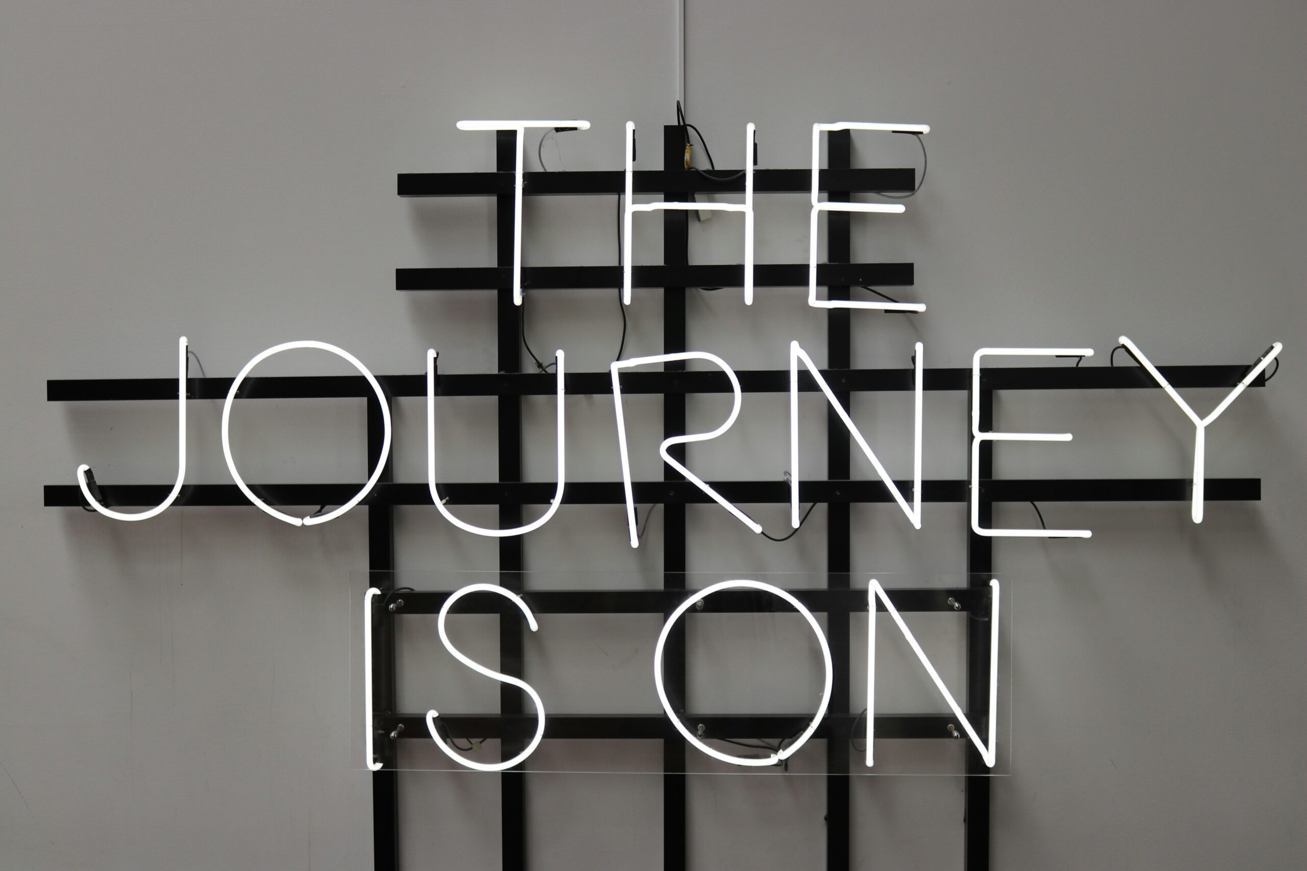 Neon sign reading 'The Journey Is On'