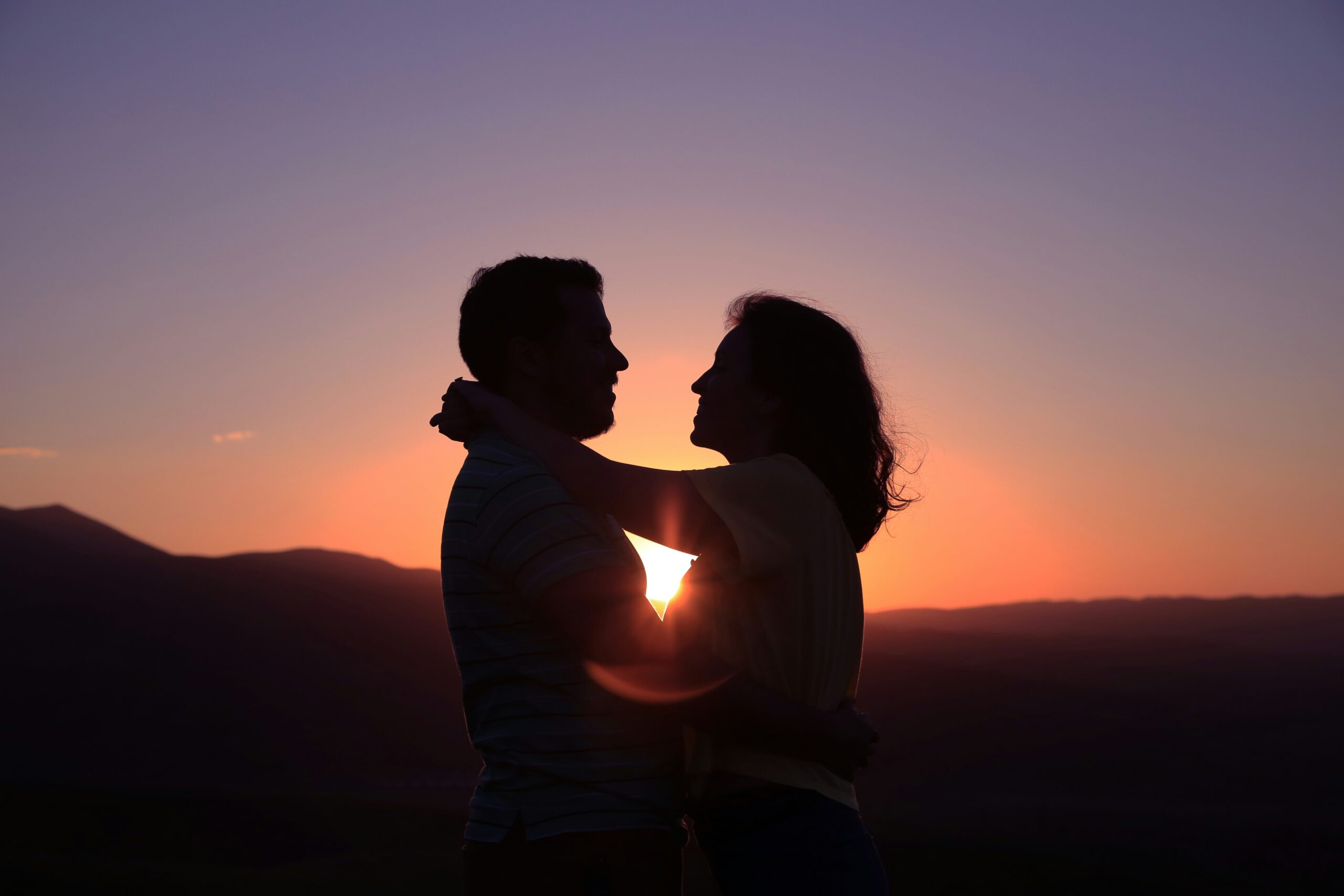 Couple embracing during sunset