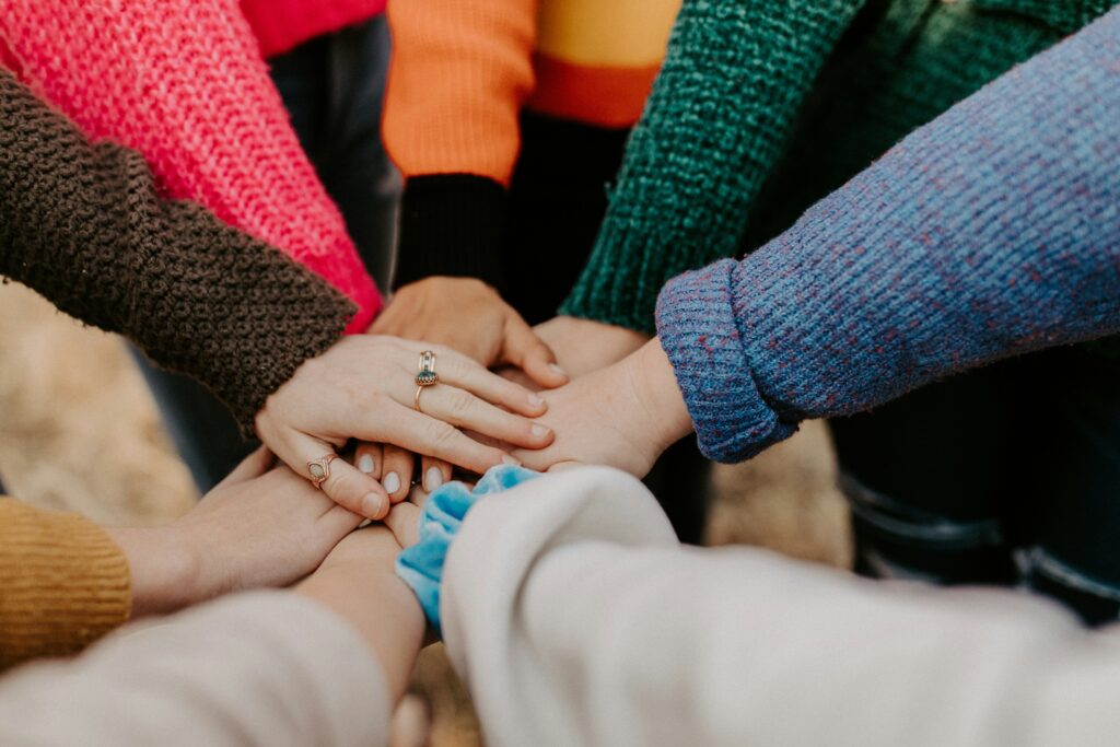 Group hands stacked in teamwork gesture.