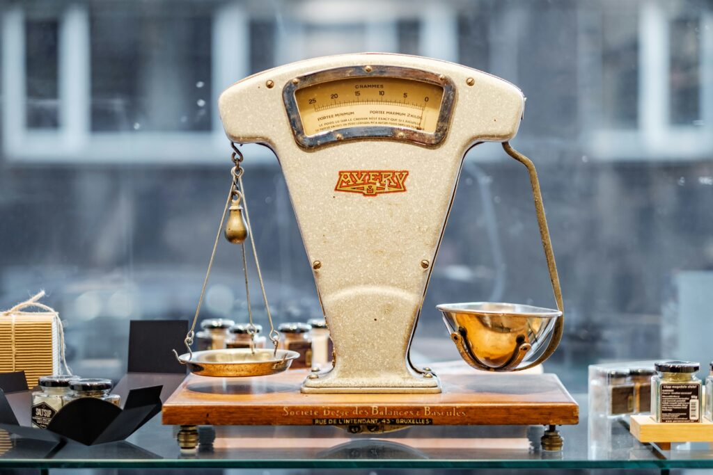 Vintage balance scale on display with weights.